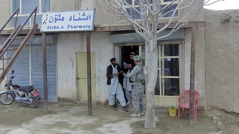 U.S. Army Spc. Andrew Stankiewicz, an infantryman with 1st Squad, 3rd Platoon, Company C, 1st Battalion, 506th Infantry Regiment, 4th Brigade Combat Team, 101st Airborne Division, and native of Kenosha, WI, distributes flyers informing the people of the Afghan Guardians of Peace Program during the squad’s visit to Jani Khel Feb. 10th. (Photo by Kurt Muncy, Task Force Currahee)