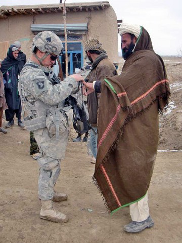 U.S. Army Pfc. Jason Conner, an infantryman with 3rd Squad, 3rd Platoon, Company C, 1st Battalion, 506th Infantry Regiment, 4th Brigade Combat Team, 101st Airborne Division, and native of Boise, Idaho, enters data related to a local villager into the Hand-Held Interagency Identity Detection Equipment during the squad’s visit to Jani Khel, Afghanistan, Feb. 10th.(Photo by Kurt Muncy, Task Force Currahee)