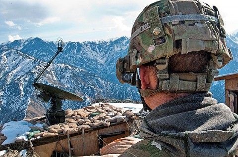 U.S. Army Sgt. Jeremy A. Wortmann looks across Observation Post Mustang during guard shift at the remote post, located 6,500 feet up in the Hindu Kush Mountains on the border of Pakistan in eastern Afghanistan’s Kunar Province Jan. 25th. Wortmann and the other Soldiers have the task to provide security for the Afghans and Americans living in the valley below. (Photo by U.S. Army Staff Sgt. Mark Burrell, Task Force Bastogne Public Affairs)