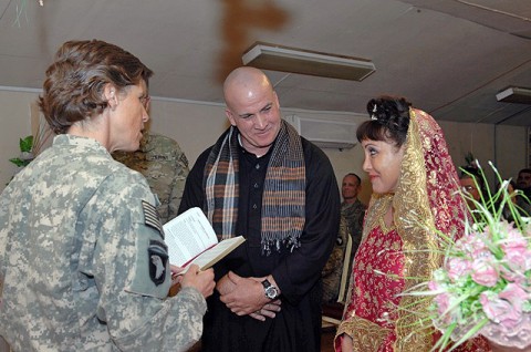 U.S Army Chaplain (Capt.) Karen A. Hallett of Vernon, NJ, performs a marriage commitment ceremony for Tony Humphreys of Pittsburgh, and Lisette Bonano of Tampa, FL, at Forward Operating Base Lightning Feb. 7th. (Photo by U.S. Air Force Tech. Sgt. Maritza Freeland, 17th Public Affairs Detachment)