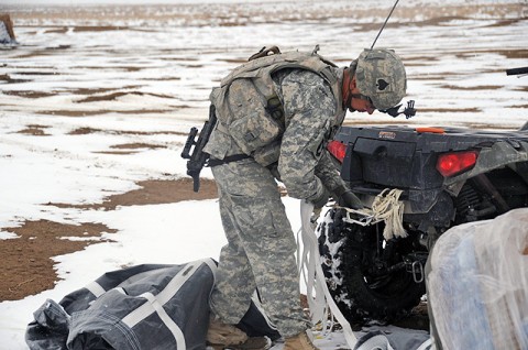 U.S. Army Sgt. 1st Class Bryan C. Reeves, platoon sergeant from Company D, 1st Battalion, 506th Infantry Regiment, and native of Houston, attaches an expended parachute to the rear of a four-wheeled all terrain vehicle to clear it from the landing zone Jan. 30th at Forward Operating Base Waza Khwah. The parachutes are used to slowly lower cargo to the landing zone. (U.S. Army photo by Spc. Kimberly K. Menzies, Task Force Currahee Public Affairs)