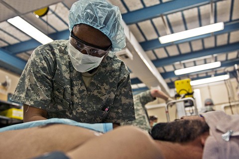 U.S. Army Pfc. Keely S. Layne, a medic from Goochland, VA, assigned to 102nd Forward Surgical Team, Task Force Bandit, 1st Brigade Combat Team, 101st Airborne Division, checks on a simulated patient during a mass-casualty exercise at Forward Operating Base Bostick in eastern Afghanistan Feb. 2nd. (Photo by U.S. Army Staff Sgt. Mark Burrell, Task Force Bastogne Public Affairs)