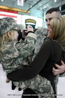 A young girl takes a photo of her mom and dad after they were reunited at the Welcome Home Ceremony A young girl takes a photo of her mom and dad after they were reunited at the Welcome Home Ceremony