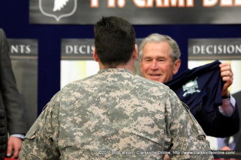 Former President George W. Bush Jr. is presented with a special forces shirt by SFC Pruitt
