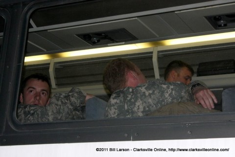 A soldier looks for his family as he waits for his turn to get off the bus.