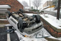 The driver was slowly dring down Jefferson Street and slid off the roadway, flipped onto the roof and landed in the parking lot of a business at Jefferson Street and North 1st Street. The 31 year old driver was uninjured. (Photo by Jim Knoll-CPD)