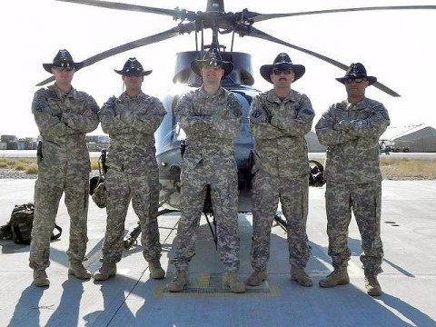 Pilots from Alpha Troop, Task Force Shooter don their Stetsons before pre-flight to remember the pilots of Adversary 11 and Adversary 22 who died Jan. 25th 2009, in Kirkuk Province, Iraq. From left, U.S. Army Capt. Scott Wohlford; U.S. Army Chief Warrant Officer 3 Justin Popp; Chief Warrant Officer 3 Filip Dziembowski; Chief Warrant Officer 5 Timothy French; and Chief Warrant Officer 3 Sascha Wellenreuther. (Photo by U.S Army Cpl. Kam Gerohimos, Task Force Shooter)