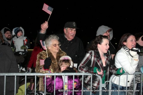 Army Wives and family members cheering for their soldiers who are returning home.