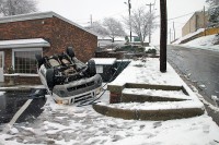 The driver was slowly dring down Jefferson Street and slid off the roadway, flipped onto the roof and landed in the parking lot of a business at Jefferson Street and North 1st Street. The 31 year old driver was uninjured. (Photo by Jim Knoll-CPD)