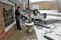 The driver was slowly dring down Jefferson Street and slid off the roadway, flipped onto the roof and landed in the parking lot of a business at Jefferson Street and North 1st Street. The 31 year old driver was uninjured. (Photo by Jim Knoll-CPD)