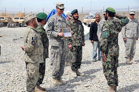 An Afghan National Army soldier from the route clearance company salutes U.S. Army Lt. Col. David B. Womack, the senior presiding officer, Task Force Currahee, and the battalion commander of 1st Battalion, 506th Infantry Regiment, before receiving his certificate of achievement during a ceremony March 21st at Forward Operating Base Sharana. (U.S. Army photo by Spc. Kimberly K. Menzies, Task Force Currahee Public Affairs)