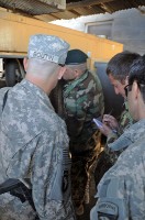 U.S. Army Sgt. Troy A. Boutin, 101st Airborne Division observes as two new generator maintainers from the Afghan National Army inspect a generator at Forward Operating Base Boris March 14th. Mai Deen, an ANA generator maintainer, examines generator damage and Mawola Khan, also a generator maintainer for the ANA, takes notes of the deficiencies found and parts needed. (Photo by U.S. Army Spc. Kimberly K. Menzies, Task Force Currahee Public Affairs)