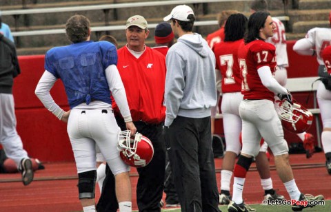 APSU coach Rick Christophel, center, and student assistant Trent Caffee, right, discuss quarterback play with Jake Ryan.  