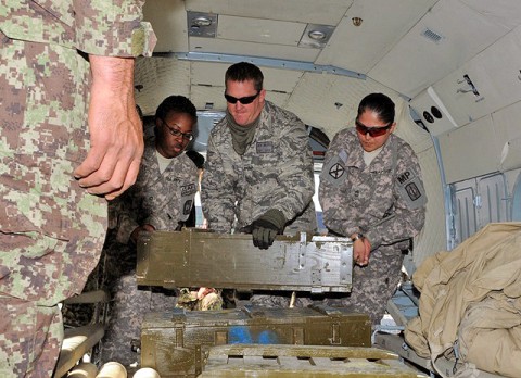 (from left) U.S. Army Pfc. Ashley N. Bell of Clarksville, TN, U.S. Air Force Capt. Drew Walters of Alamosa, CO, and U.S. Army Sgt. 1st Class Paula G. Jennings of Corpus Christi, TX, load ammo onto an Afghan helicopter to resupply Afghan troops in Kunar Province along the eastern Afghanistan border March 10th. (Photo by U.S. Army Spc. Richard Daniels Jr., Task Force Bastogne Public Affairs)