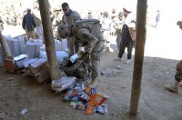 U.S. Army Spc. Stephen Hirt, an imagery analyst with Task Force Currahee, Company B, 4th Brigade Special Troops Battalion, 4th Brigade Combat Team, 101st Airborne Division, a native of Anaheim, CA, and member of the Islamic faith, delivers school supplies donated by his mosque in California to Afghan children in a village west of Forward Operating Base Sharana, March 14th. (Photo by U.S. Army Sgt. Christina Sinders, Task Force Currahee Public Affairs)