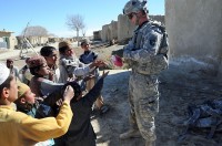 U.S. Army Spc. Stephen Hirt, an imagery analyst with Task Force Currahee, Company B, 4th Brigade Special Troops Battalion, 4th Brigade Combat Team, 101st Airborne Division, a native of Anaheim, CA, and member of the Islamic faith, delivers school supplies donated by his mosque in California to Afghan children in a village west of Forward Operating Base Sharana, March 14th.(Photo by U.S. Army Sgt. Christina Sinders, Task Force Currahee Public Affairs)