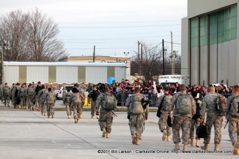 The returning soldiers stream past their assembled family members to form up to march in for the Welcome Home Ceremony