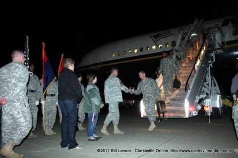 Brig. Gen. Jeffery N. Colt greets the returning soldiers as they step off the airplane