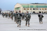 Soldiers stream back towards the hanger and the familes that await them