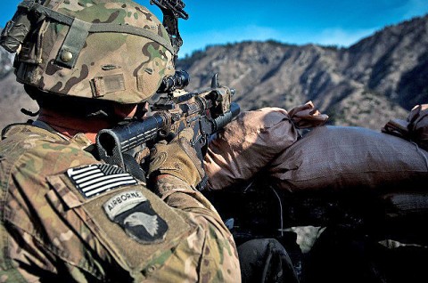 From behind his makeshift fighting position, U.S. Army Sgt. Nathaniel S. Gray, an infantry squad leader from Tupelo, MS, 101st Airborne Division, uses his combat optics to search for insurgent fighters during a recent combat operation in Shigal District of eastern Afghanistan's Kunar Province March 16th. Gray is a single parent with twin sons at home. (Photo by U.S. Army Sgt. 1st Class Mark Burrell, Task Force Bastogne Public Affairs)