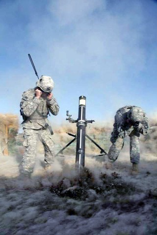 U.S. Army Spc. Nicholas Ketchen and U.S. Army Spc. Colt Corbin achieved a first in the U.S. Army history by firing a 120mm Mortar Precision Guided Munition for the first time and hitting within four meters of the target on Forward Operation Base Kushamond March 26th.  (Photo by U.S. Army Spc. Zachary Burke, 55th Combat Camera)