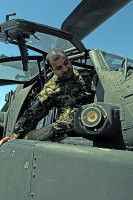 Afghan air force Maj. Gen. Abdul Razik Sherzai, the commander of the Kandahar Air Wing, climbs into the cockpit of an AH-64 Apache helicopter here during a visit with the Task Force Thunder April 2nd. (Photo by Sgt. 1st Class Stephanie Carl)