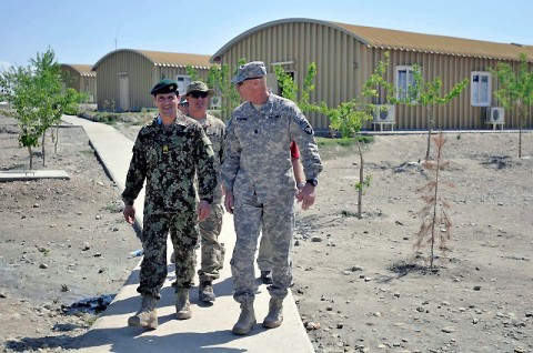 Afghan National Army 201st Corps Command Sgt. Maj. Ziaulhaq Amanzai gives a tour of Foward Operating Base Gamberi to U.S. Army Command Sgt. Maj. Scott Schroeder, Combined Joint Task Force-101 and Regional Command – East command sergeant major, after receiving the Sgt. Audie Murphy Award March 30th. Amanzai is believed to be the first Afghan noncommissioned officer to receive this award. (Photo by U.S. Army Sgt. Scott Davis, Combined Joint Task Force-101 Public Affairs)