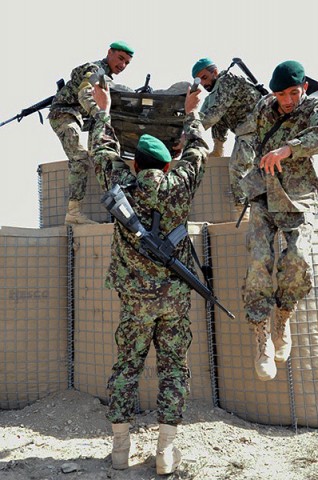 Afghan National Army medics carry a simulated casualty over an obstacle during a combat medical competition held by U.S. Army Task Force Currahee Soldiers the 101st Airborne Division, April 5th. (Photo by U.S. Army Sgt. Luther L. Boothe Jr., Task Force Currahee Public Affairs)