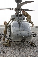 Chief Warrant 4 Anne Wiley (left), the senior standardizations instructor pilot for 7th Squadron, 17th Cavalry Regiment, and Capt. Carmel Cammack, an assistant operations officer for the unit, both OH-58D Kiowa pilots, conduct pre-flight inspections on their aircraft at Kandahar Air Field, Afghanistan. (Photo by Sgt. 1st Class Stephanie Carl)