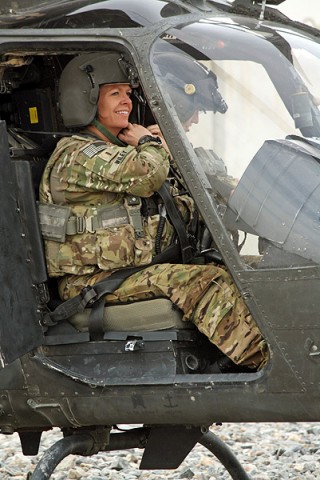 Chief Warrant 4 Anne Wiley (left), the senior standardizations instructor pilot for 7th Squadron, 17th Cavalry Regiment, and Capt. Carmel Cammack, an assistant operations officer for the unit, both OH-58D Kiowa pilots, prepare to reposition an aircraft at Kandahar Air Field, Afghanistan. (Photo by Sgt. 1st Class Stephanie Carl)