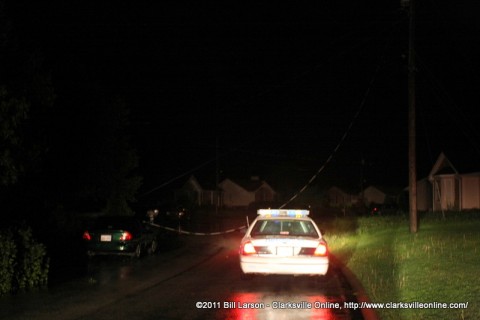 A utility line lays across the road and a vehicle before coming to rest on a house in the ringold area