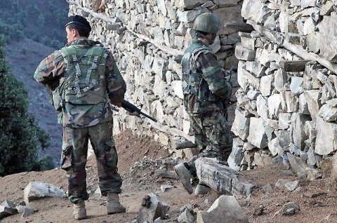 An Afghan National Army soldier enters a house in Marawara District during a joint clearing, Operation Strong Eagle III, with Task Force No Slack Soldiers assigned to 1st Brigade Combat Team, 101st Airborne Division, Task Force Bastogne, in eastern Afghanistan's Kunar Province March 29th. Insurgents used the area to stage attacks on International Security Assistance Forces and civilians. (Photo by U.S. Army Pfc. Cameron Boyd, 982nd Combat Camera)