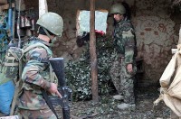 An Afghan National Army soldier provides security while another ANA soldier searches a house in Marawara District during Operation Strong Eagle III in eastern Afghanistan's Kunar Province March 29th. Afghan National Security Forces worked closely with coalition forces from 2nd Battalion, 327th Infantry Regiment, 1st Brigade Combat Team, 101st Airborne Division, Task Force Bastogne. (Photo by U.S. Army Pfc. Cameron Boyd, 982nd Combat Camera)