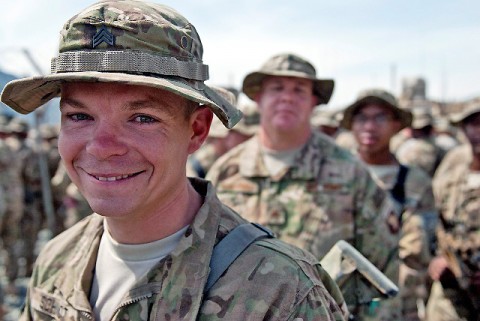 U.S. Army Sgt. James Schmidt, an infantry squad leader assigned to Task Force No Slack, 1st Brigade Combat Team, 101st Airborne Division, lines up to shake hands with Gen. David H. Petraeus, International Security Assistance Forces commander, after a re-enlistment ceremony at Forward Operating Base Joyce in eastern Afghanistan's Kunar Province April 11th. (Photo by U.S. Army Sgt. 1st Class Mark Burrell, Task Force Bastogne Public Affairs)