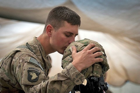 U.S. Army Spc. Brit B. Jacobs, a combat medic from Sarasota, FL, Task Force No Slack, 101st Airborne Division, gives a farewell kiss to the helmet of one of his fallen comrades during a memorial service for six fallen U.S. Soldiers at Forward Operating Base Joyce in eastern Afghanistan's Kunar Province April 9th. (Photo by U.S. Army Sgt. 1st Class Mark Burrell, Task Force Bastogne Public Affairs)