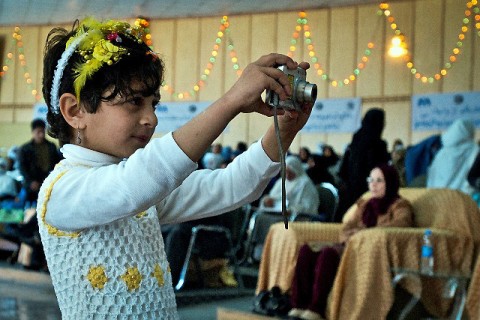 An Afghan girl, who dreams of being a journalist, takes photos during International Women's Day at the governor's house in Jalalabad in eastern Afghanistan's Nangarhar Province March 8th. (Photo by U.S. Army Sgt. Ginifer Spada, Task Force Bastogne Public Affairs)