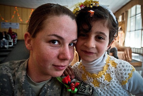 U.S. Army Sgt. Ginifer Spada, a broadcast journalist assigned to the public affairs office for 1st Brigade Combat Team, 101st Airborne Division, Task Force Bastogne, poses with an Afghan girl who wants to be a journalist during International Women's Day at the governor's house in Jalalabad in eastern Afghanistan's Nangarhar Province March 8th. (Photo by U.S. Army Sgt. Ginifer Spada, Task Force Bastogne Public Affairs)