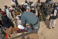 Afghan National Police distribute humanitarian assistance supplies to villagers in Deh Gholaman in Kandahar province, Afghanistan March 18th. The goods were donated by individuals and companies in the U.S., shipped to Kandahar Airfield, then flown to the village by helicopters from the 159th Combat Aviation Brigade. (Photo by Sgt. 1st Class Stephanie Carl)