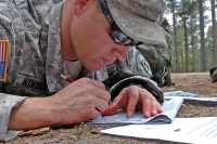 Staff Sgt. Samuel Winslow, a weapons sergeant with the 10th Special Forces Group (Airborne), plots his coordinates during a land navigation event as part of the 2011 USASFC (A) Soldier and NCO of the Year Competition, May 9th. Winslow was named the 2011 USASFC NCO of the Year, and will represent the command at the USASOC level competition in June. (Photo by Spc. Michael Creech, Combat Camera, 3rd Special Forces Group) 