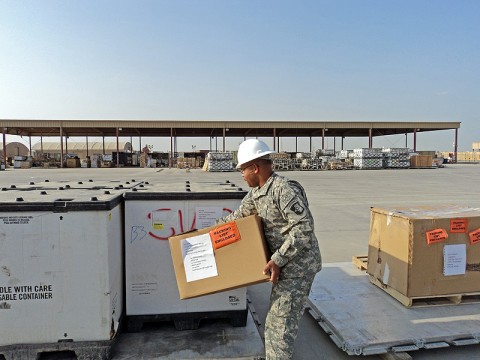 Ensuring supplies reach the soldiers it needs is the priority for the 101st Sustainment Brigade's Liaison Office. Here, Staff Sgt. Larry Dixon, LOG expeditor non-commissioned officer, is preparing bundles at the yard. (Courtesy Photo)