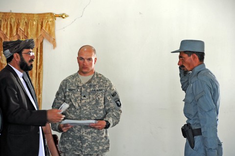 Paktika Province Gov. Habibullah Samim hands a certificate of training to Afghan Uniformed Policeman Wali Jan, the Distinguished Honor Graduate of the AUP’s advanced training during a graduation ceremony in Paktika Province, Afghanistan, May 15th. (Photo by U.S. Army Staff Sgt. Matt Graham, Task Force Currahee Public Affairs)