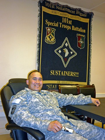 Spc. Jerry Leal, a supply clerk for the logistics section of the 101st Special Troops Battalion, 101st Sustainment Brigade, pose in the STB conference room at Bagram Air Field. Leal has been with the unit for six years, and he has witnessed the transformations in mission, names and insignias for the STB and the 101st Sust. Bde. (Photo by Spc. Michael Vanpool)