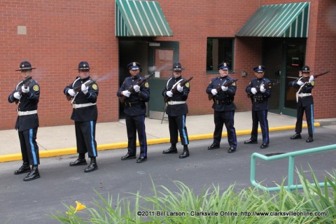 The CPD Honor Guard fires a salute in honor of the fallen police officers