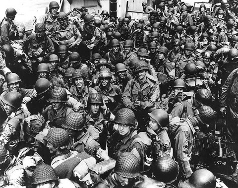 Army troops on board a LCT, ready to ride across the English Channel to France. Some of these men wear 101st Airborne Division insignia. Photograph released 12th June 1944. (Official U.S. Navy Photograph, National Archives.)