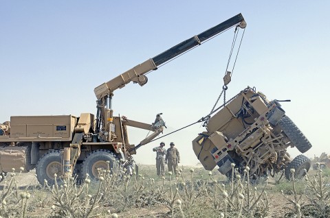 Spc. Larry Smith, a mechanic with the 131st Transportation Company, a Pennsylvania National Guard unit attached to the 101st Sustainment Brigade, and Sgt. 1st Class Alvin Beehler, the chief instructor for the vehicle recovery course from the 59th Ordnance Brigade, US Army Ordnance Center and School, flip a mine resistant ambush-protected vehicle with an M984 HEMTT wrecker. (Photo by Spc. Michael Vanpool) 