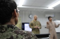 An airman with the Afghan air force’s Kandahar Air Wing (right) ponders Sgt. 1st Class Clinton Bruce’s question about ambiguous language problems during a class to improve crew coordination. (U.S. Army photo by By Spc. Jennifer Andersson)