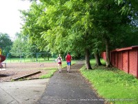 Two joggers make their way around the park on their morning run