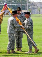 Col. Bill Gayler, 101st Combat Aviation Brigade commander, passes the 2nd Squadron, 17th Cavalry Regiment Colors to Lt. Col. Michael Harvey, the squadrons incoming commander, during a change of command ceremony June 21st, 2011 at Fort Campbell, KY. (101st Combat Aviation Brigade Public Affairs Noncommissioned Officer Tracy R. Weeden/Released)