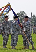 Col. Bill Gayler, 101st Combat Aviation Brigade commander, passes the 6th Battalion, 101st Aviation Regiment Colors to Lt. Col. Joel Aoki, the incoming battalion commander, during a change of command ceremony June 20th, at Fort Campbell, KY.