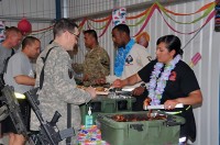 A volunteer for a special event celebrating Asian Pacific Heritage Month at Forward Operating Base Sharana, Afghanistan, serves traditional Korean marinated beef to a U.S. Army Soldier who joined the festivities, May 29th. (Photo by U.S. Army Sgt. Christina Sinders, Task Force Currahee Public Affairs)